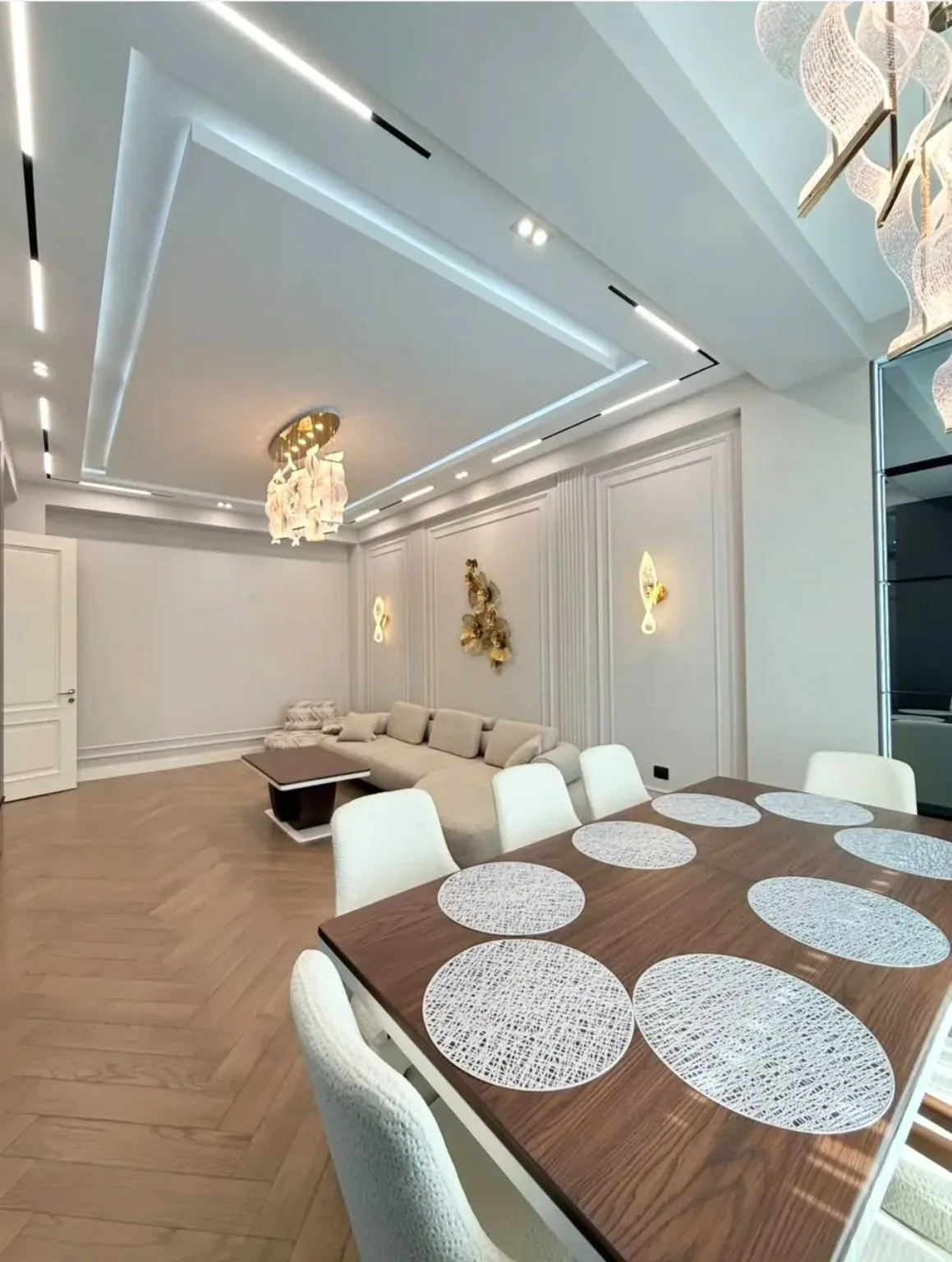 Elegant open-plan living and dining area with coordinated furniture and lighting