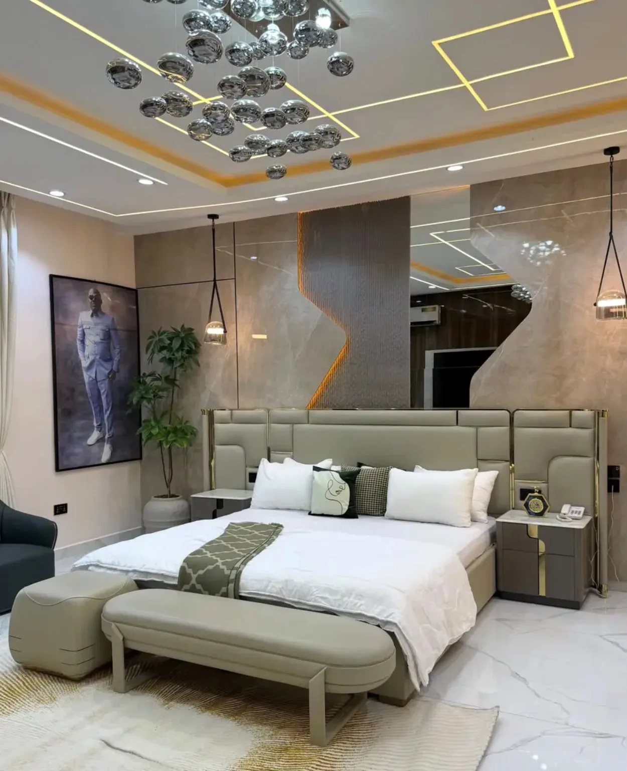 Luxury master bedroom furnished with upholstered bed, bench, bedside tables and decor